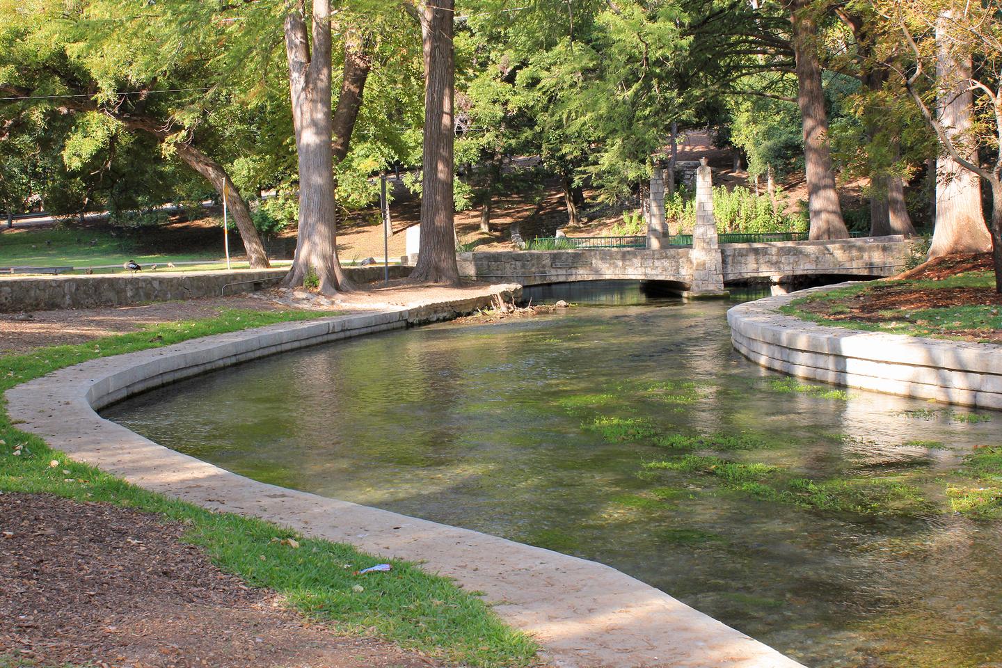 The Comal River flowing under trees in Landa Park, New Braunfels